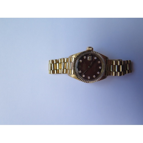 647B - A Ladies Rolex Oyster 18ct Gold Datejust Wristwatch with maroon diamond set dial, 2030 movement no. ... 