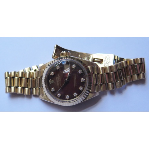 647B - A Ladies Rolex Oyster 18ct Gold Datejust Wristwatch with maroon diamond set dial, 2030 movement no. ... 