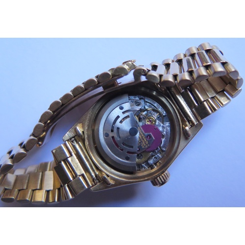 647B - A Ladies Rolex Oyster 18ct Gold Datejust Wristwatch with maroon diamond set dial, 2030 movement no. ... 