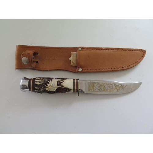 716 - An Hoffritz Sheath Knife with decorative blade and carved antler handle, 30.5cm overall length and f... 