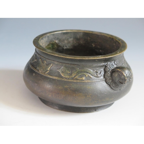 649 - A Chinese Bronze Censer with bird and bat border and mask handles, four character mark to base, 14.5... 