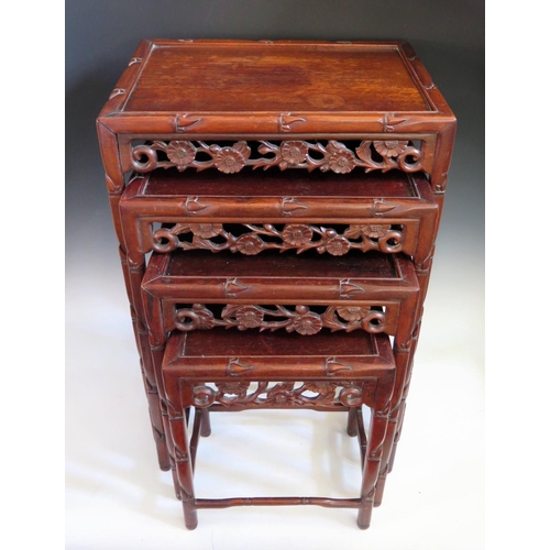 688 - A Chinese Rosewood Nest of Three Tables with carved and pierced foliate apron and stylised bamboo le... 