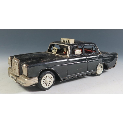 102 - A Scarce Ichiko Tinplate Mercedes Benz Taxi Cab in Black Made in Japan (19cm approx).