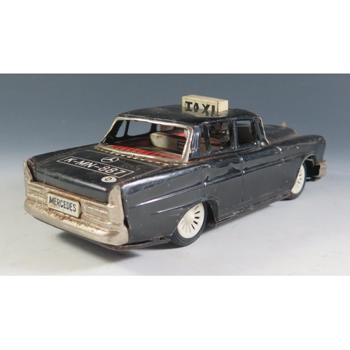 102 - A Scarce Ichiko Tinplate Mercedes Benz Taxi Cab in Black Made in Japan (19cm approx).