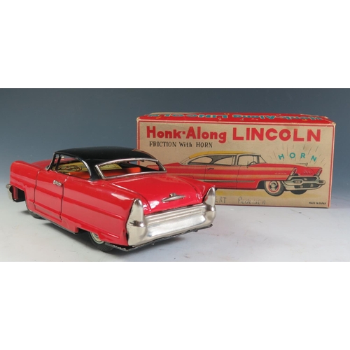 104 - A Kanto Toys Honk-Along Tinplate Lincoln in red and black in original box Made in Japan. The push al... 