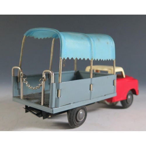 127 - A Chinese Made Tinplate Canopied Truck with Retracting Ladder in Red, Cream and Blue-Grey.