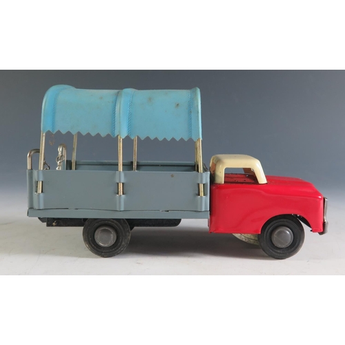 127 - A Chinese Made Tinplate Canopied Truck with Retracting Ladder in Red, Cream and Blue-Grey.