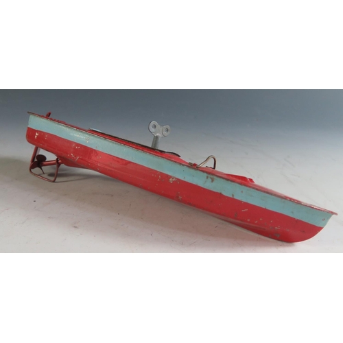 134 - A Triang Clockwork Tinplate Boat in Red and Blue, working motor(26cm approx).