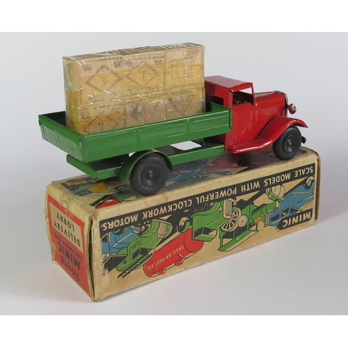 17 - A Triang Minic Clockwork Delivery Lorry in red and green with black hubs. It is in near mint working... 