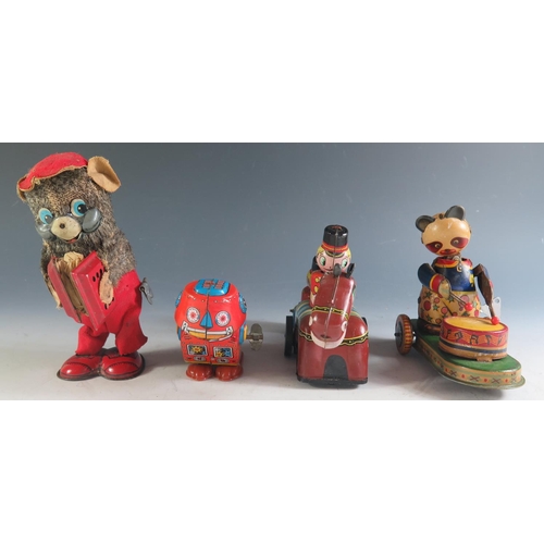 170 - Four Clockwork Tinplate Toys Including a Drumming Pander, Accordion playing bear, Robot and Guardsma... 