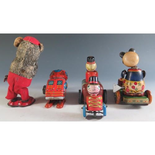 170 - Four Clockwork Tinplate Toys Including a Drumming Pander, Accordion playing bear, Robot and Guardsma... 