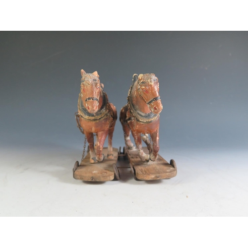 177 - A Pair of 19th Century Composite Cart Horses on wheeled wooden plinths (Overall length 19.5cm approx... 