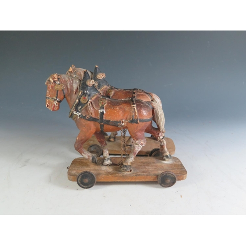 177 - A Pair of 19th Century Composite Cart Horses on wheeled wooden plinths (Overall length 19.5cm approx... 