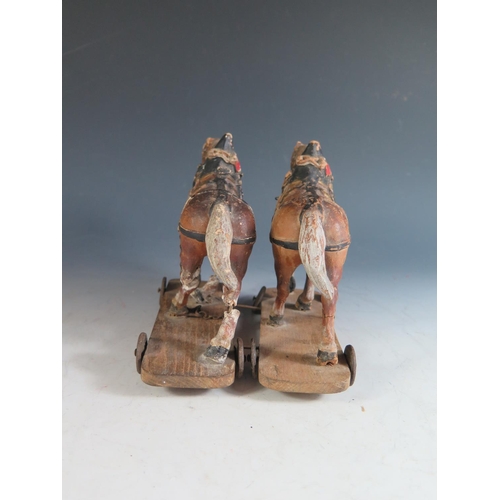 177 - A Pair of 19th Century Composite Cart Horses on wheeled wooden plinths (Overall length 19.5cm approx... 