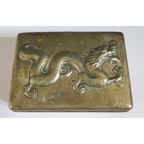 326 - A Chinese Silver Box decorated with an embossed dragon to the hinged lid, rubbed marks to base, 237g... 