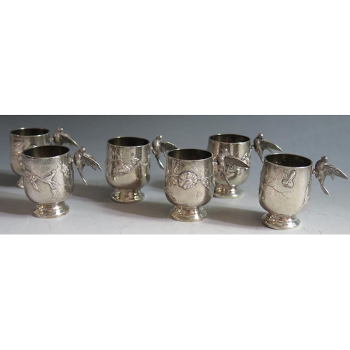 332A - A Set of Six French Silver Spirit Tots with applied bird handle and embossed foliate and insect deco... 