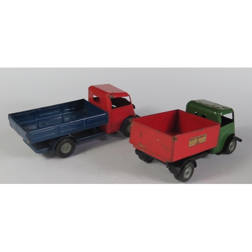 34 - Two Triang Minic Clockwork Trucks. One in red and blue with working motor the other has a tipping be... 