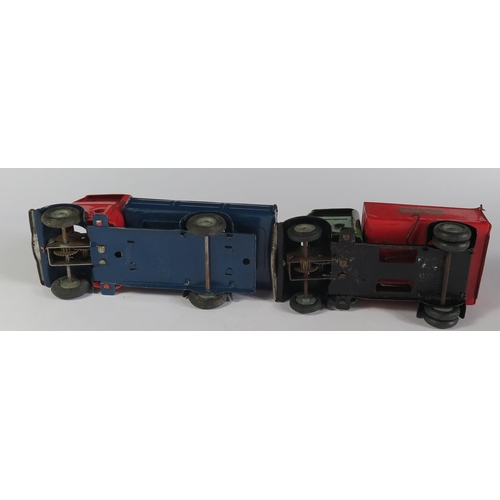 34 - Two Triang Minic Clockwork Trucks. One in red and blue with working motor the other has a tipping be... 