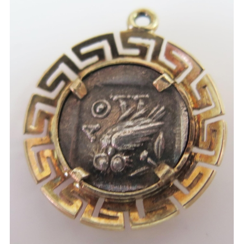 452 - An Unmarked Gold Charm set with a white metal central disc portraying Athena and owl, 2.9g, 20mm