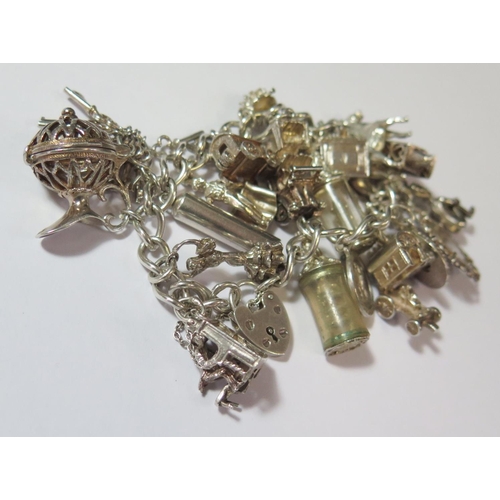 478 - A Heavy Silver Charm Bracelet, 85.7g