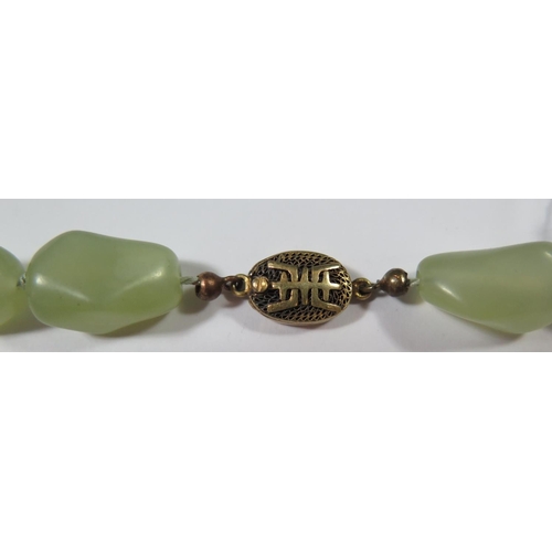 487 - A Chinese Jadeite Necklace with silver gilt clasp, 48cm long, 115g