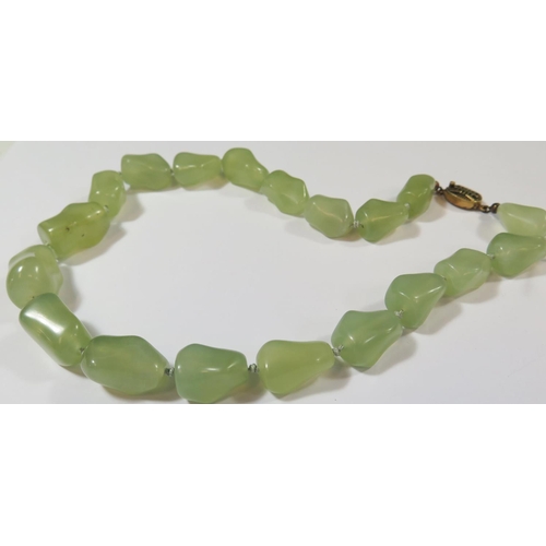 487 - A Chinese Jadeite Necklace with silver gilt clasp, 48cm long, 115g