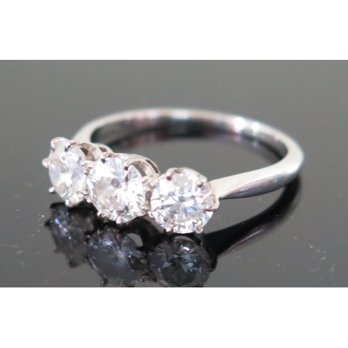 505a - A Three Stone Diamond Ring in an unmarked precious white metal setting (probably platinum), size N, ... 