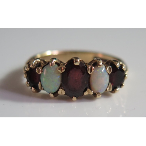 506 - A 9ct Gold, Opal and Garnet Five Stone Ring, size N, 3.8g