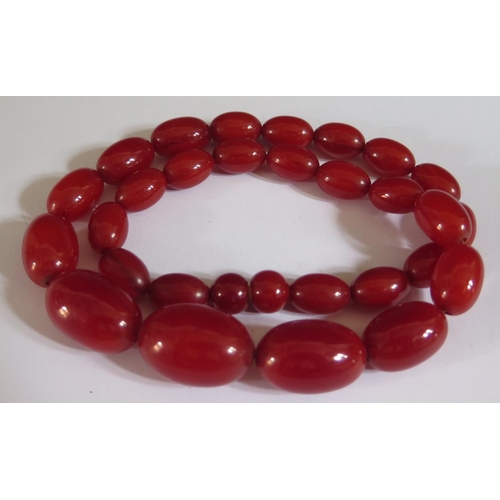 511 - A Faux Red Amber Bead Necklace, 47cm, largest bead 25x17mm, 43g