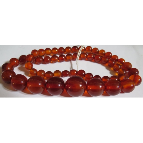 515 - A Graduated Faux Orange Amber Bead Necklace, 62cm, 65.5g