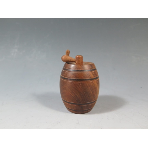 565 - A Carved Treen Barrel Tape Measure, 7cm tall