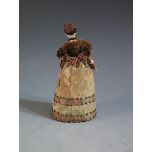 574 - An Early 18th Century Doll Pin Cushion with painted wooden head and jointed arms, 11.5cm tall