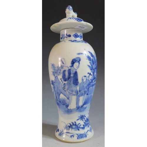 660 - An 18th Century Chinese Blue and White Porcelain Baluster Vase with cover, decorated with a lady hol... 