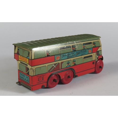 69 - A Wells Brimtoy Tinplate 6 Wheeled Double Deck Bus. Working but no key. (10.5cm approx).