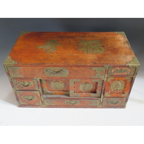 692 - A Small Chinese Elm and Brass Mounted Multiple Drawer Chest with twin sliding doors, the brass mount... 