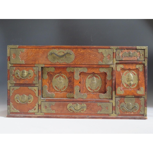 692 - A Small Chinese Elm and Brass Mounted Multiple Drawer Chest with twin sliding doors, the brass mount... 