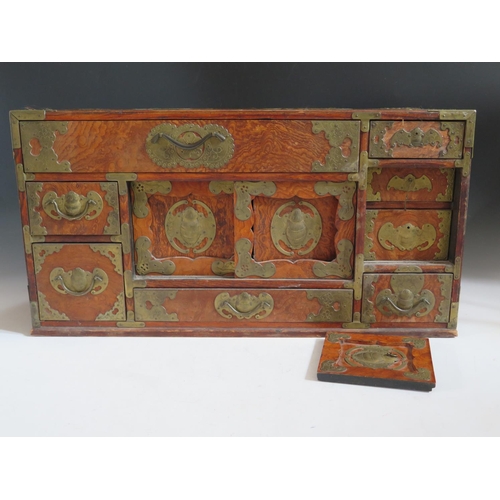 692 - A Small Chinese Elm and Brass Mounted Multiple Drawer Chest with twin sliding doors, the brass mount... 