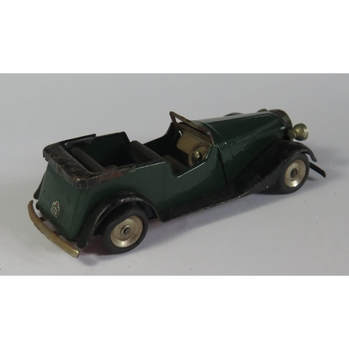 7 - A Triang Minic 19M Vauxhall Open Tourer Car in dark green and black with red base. Motor works.