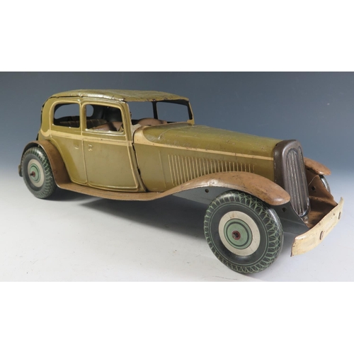 79 - A Large Scale Mettoy Clockwork Tinplate Car in Olive Green with cream detailing and light brown side... 