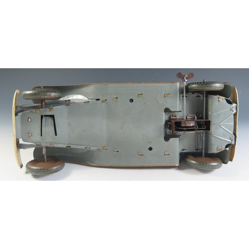 79 - A Large Scale Mettoy Clockwork Tinplate Car in Olive Green with cream detailing and light brown side... 