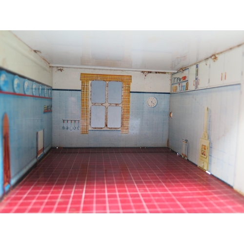 82b - A Mettoy Tinplate Dolls House with Living Room, Kitchen, 2 Bedrooms  and a Bathroom. (approx 48.5x22... 