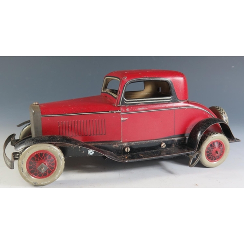 84 - A Chad Valley Ubuilda Clockwork Tinplate Burnett 2 Door Coupe Car in red and black (25.5cm approx) w... 