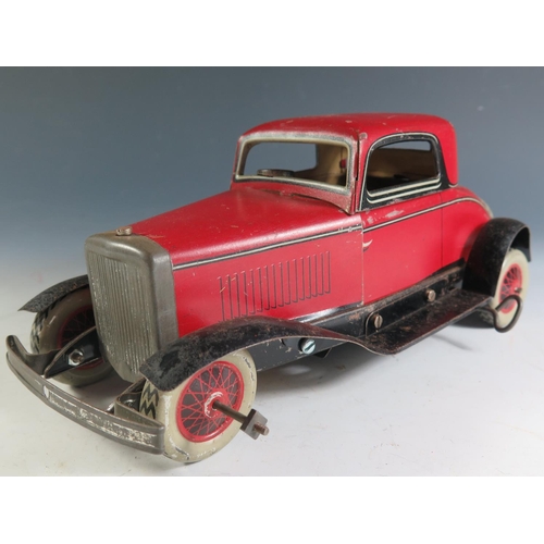 84 - A Chad Valley Ubuilda Clockwork Tinplate Burnett 2 Door Coupe Car in red and black (25.5cm approx) w... 