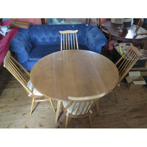 691 - An Ercol Light Elm Drop Leaf Table with four spindle back chairs