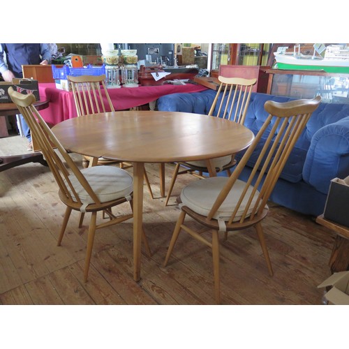 691 - An Ercol Light Elm Drop Leaf Table with four spindle back chairs