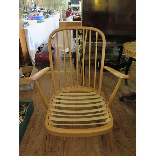 690 - An Ercol Light Elm Spindle Back Open Arm Chair, (cushions are not sold with this chairs because of f... 