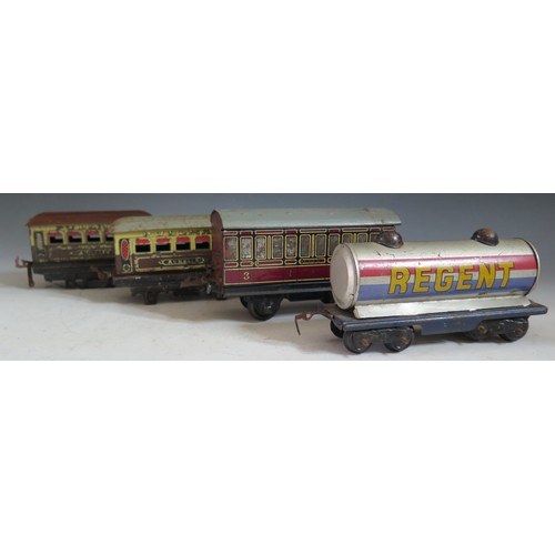 277 - Three Tinplate Hornby Passenger Carriages (two missing wheels) and one other of a different make.