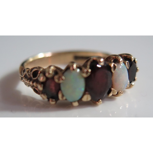 513A - A 9ct Gold, Opal and Garnet Five Stone Ring, size N, 3.8g