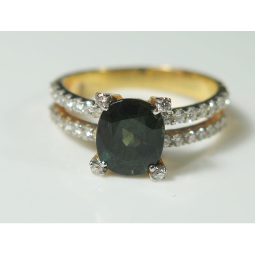 502 - A Green Sapphire and Diamond Ring in an unmarked gold setting, size M, 3.4g. (phone bid in 10x2)