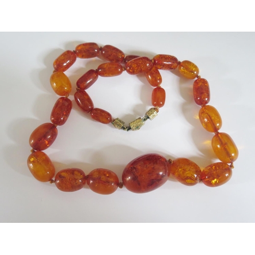 524 - An Amber Bead Necklace, 73cm, largest bead 40x29mm, 112g